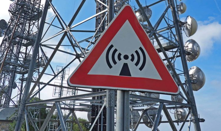 Metal sign with danger of 5G electromagnetic waves.